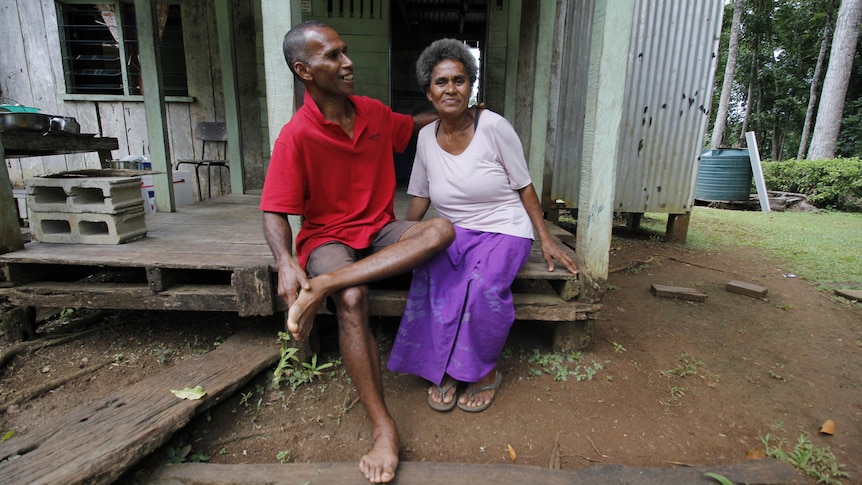 Amenatape and Sanita Waait Volavola sitting on the step of their family home