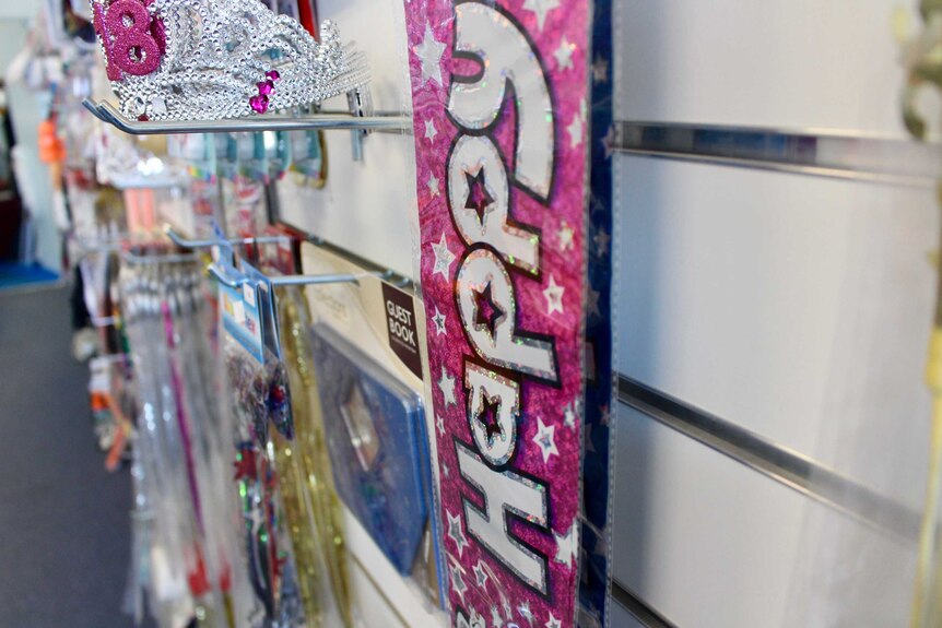 happy pink ribbon hangs in party shop