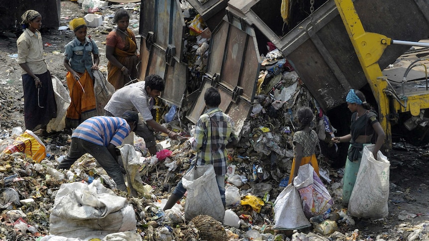 Rag pickers sort through garbage in India