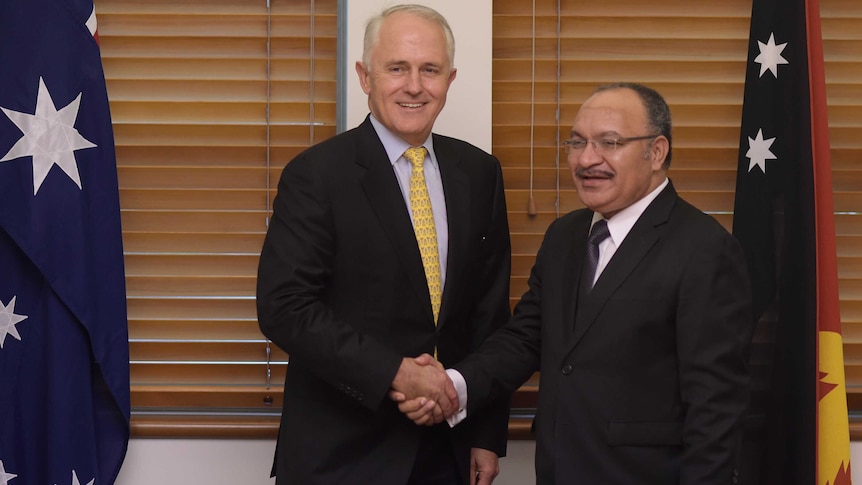 Malcolm Turnbull (left) shakes hands with Peter O'Neill