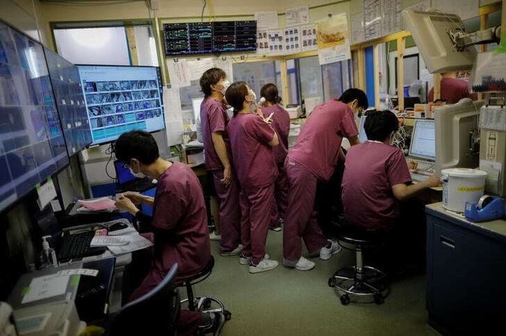 A group of doctors in a nurse's station in a Japanese hospital