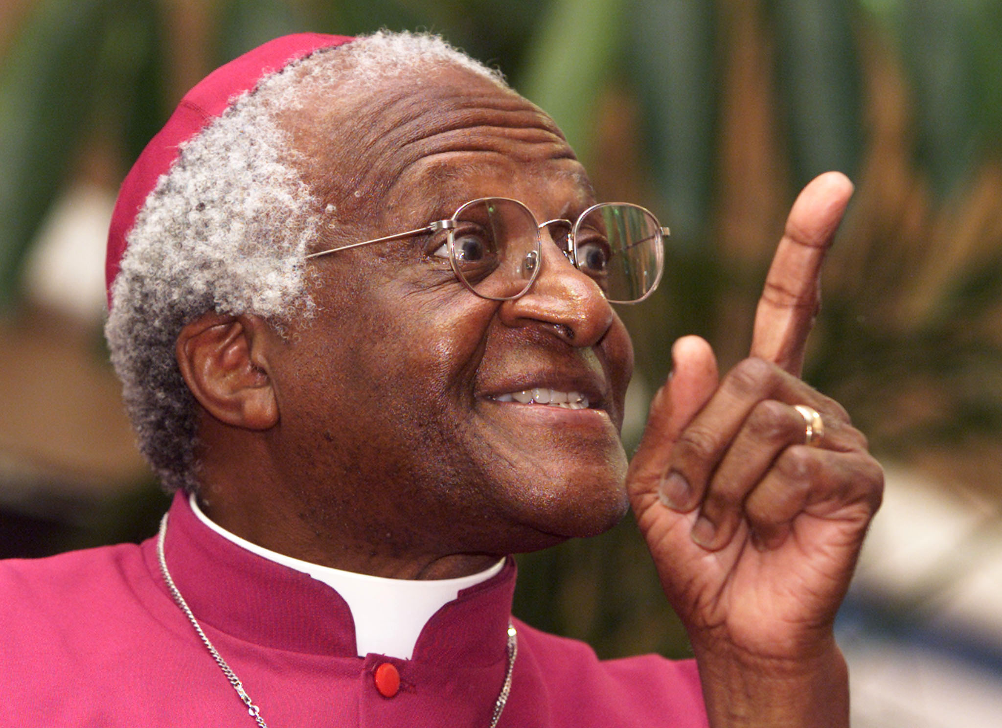 Archbishop Desmond Tutu smiles and points