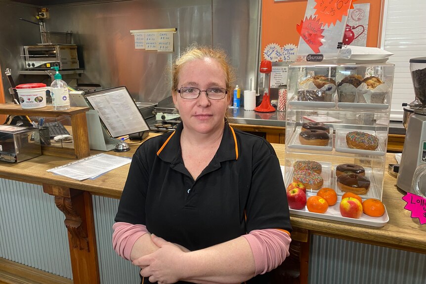 A woman wearing a black polo shirt in a shop