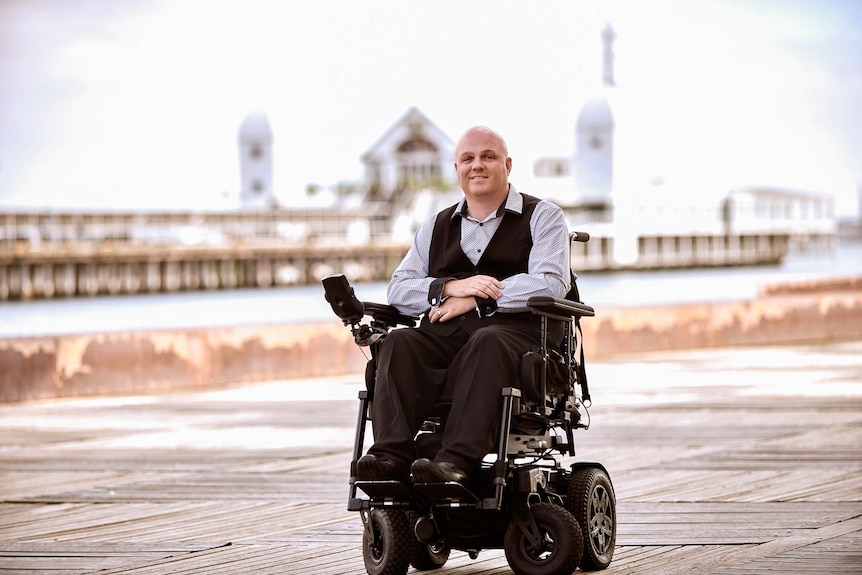 A profile shot of Tim McCallum in his wheelchair Ausnew Home Care, NDIS registered provider, My Aged Care