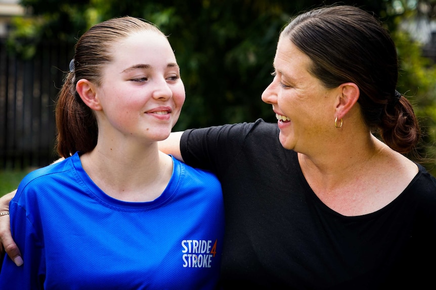 Megan is wearing a black shirt and smiling warmly at her daughter Kaylah.