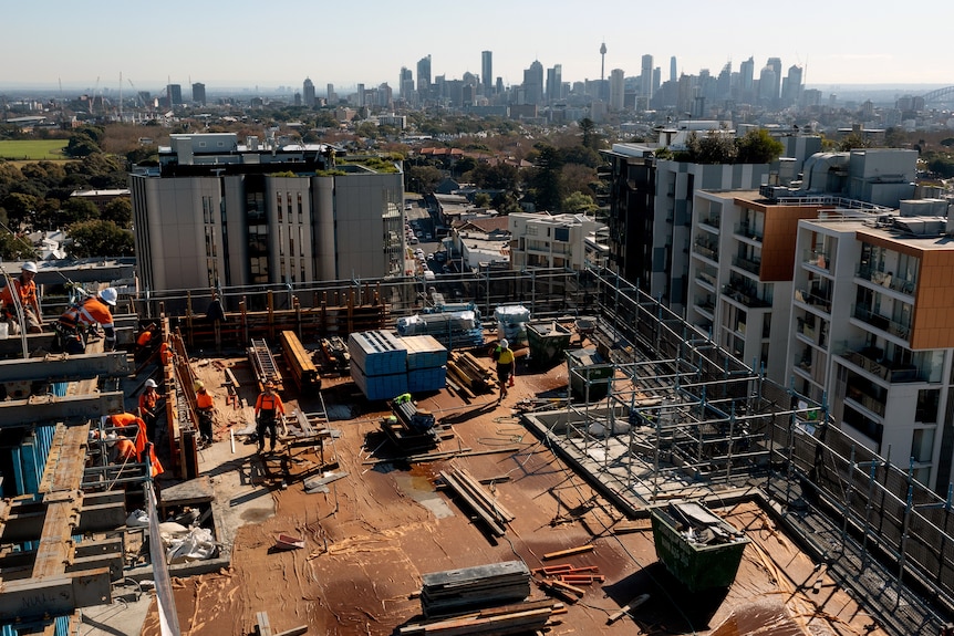 Workers labour at the construction site of a Sydney apartment block