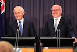 Malcolm Turnbull and George Brandis smile while addressing media.