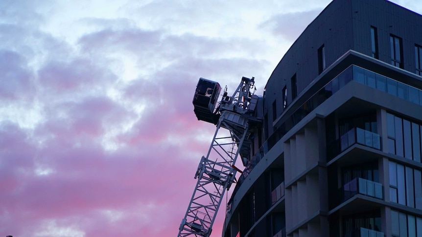 A collapsed crane resting against a damaged apartment block at Wolli Creek in Sydney's south.