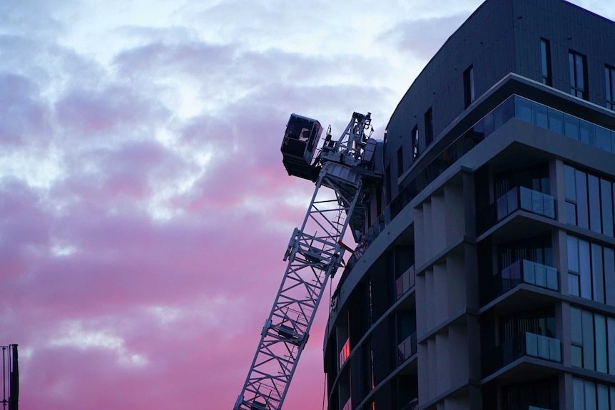 A collapsed crane resting against a damaged apartment block at Wolli Creek in Sydney's south.