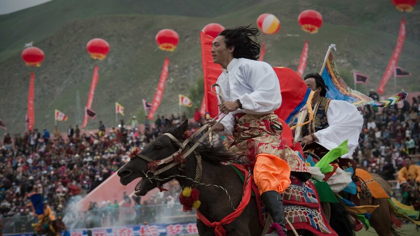 Tibetan horse rider takes part in the annual riding festival in traditional dress.