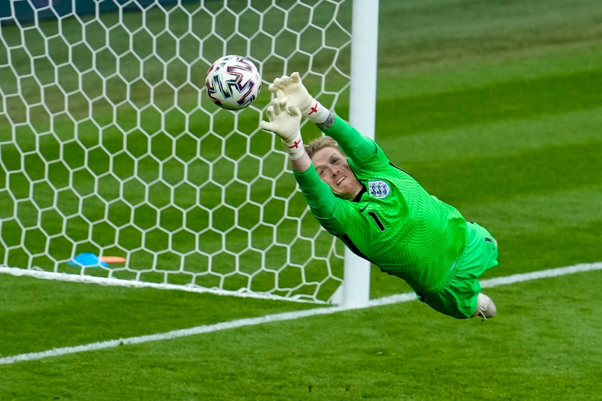 Jordan Pickford makes a save, diving at full stretch with both hands