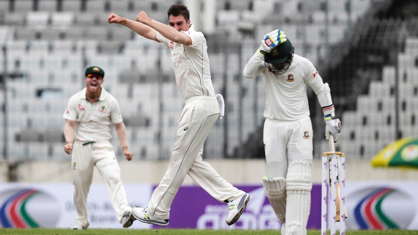 Australia's Pat Cummins (C), celebrates the wicket of Bangladesh's Sabbir Rahman in Dhaka.