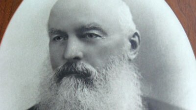 Black and White phot of Algenon Henry Belfield, bald but for a bushranger style beard