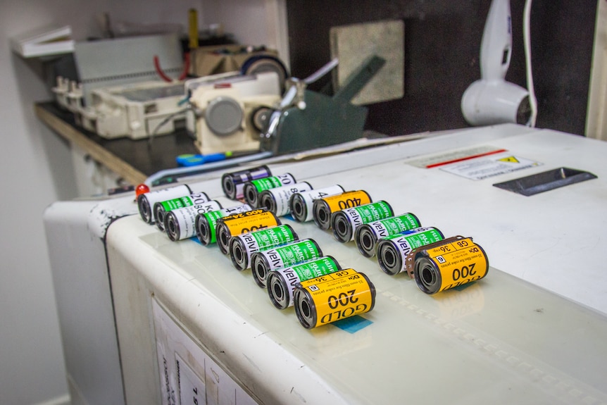 Film canisters lined up to be processed.