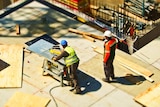 A high shot showing two men working on a construction site.