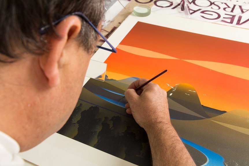 Duncan paints over an artwork.