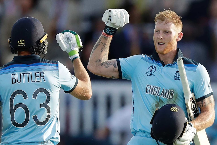 Jos Buttler, from behind, and Ben Stokes, from in front, are mid-fist bump in the super over of the Cricket World Cup final.
