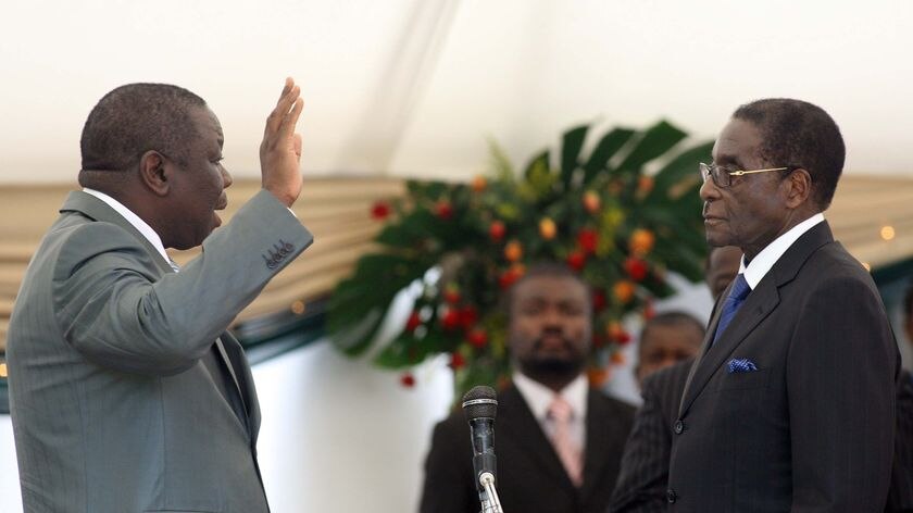 Morgan Tsvangirai is sworn in by Robert Mugabe