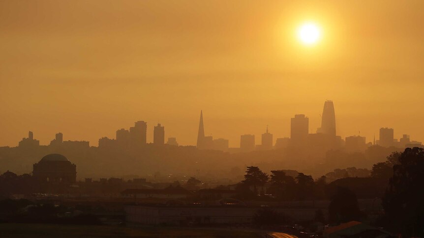 A wide-shot of San Francisco shows the skyline turned orange from nearby fires.