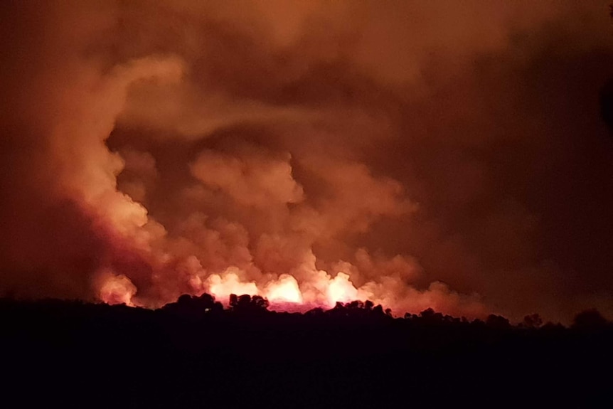 A night time photo of a fire burning at Boyatup, with a bright orange sky.