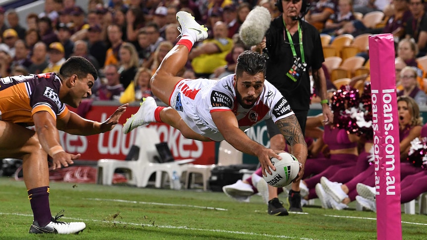 Jordan Pereira dives in mid-air as he tries to ground the ball with his right hand.