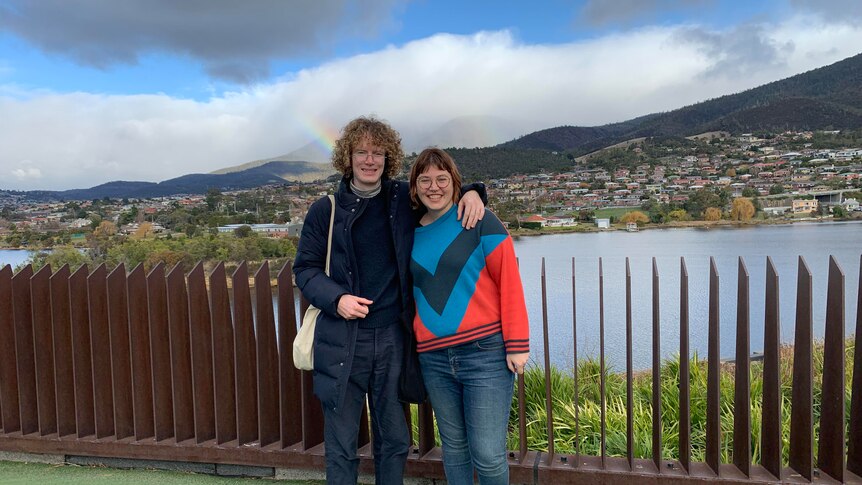 Sian Campbell and husband Murray stand in front of a beautiful vista in Tasmania.