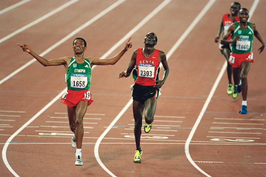 Epic contest ... Paul Tergat (C) crosses the line second to Haile Gebrselassie at the Sydney Olympics