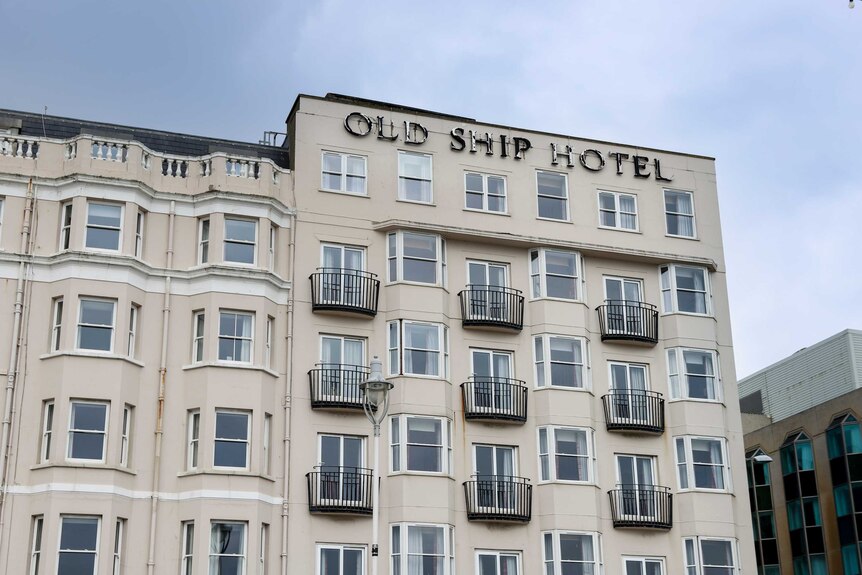 Exterior of a low-rise building  bearing the words: Old Ship Hotel.