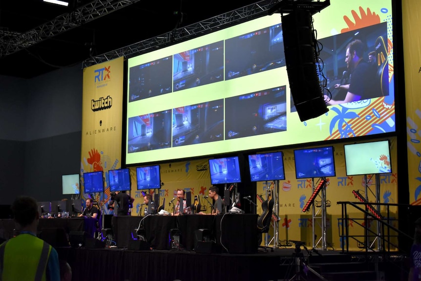 A series of screens on-stage during an event at the Rooster Teeth convention in Sydney.