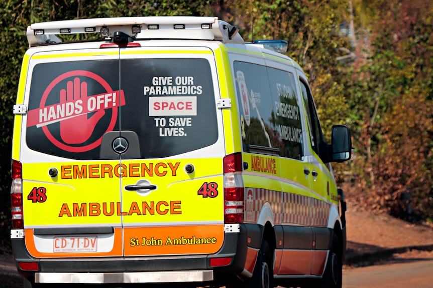 A St John Ambulance NT vehicle driving along a road in suburban Darwin.