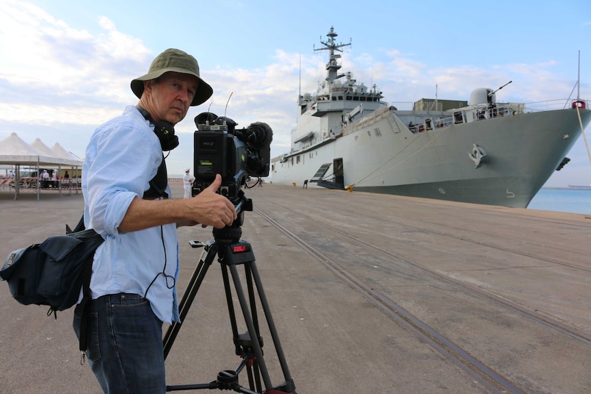 Foreign Correspondent cameraman Dave Martin films the San Giusto.
