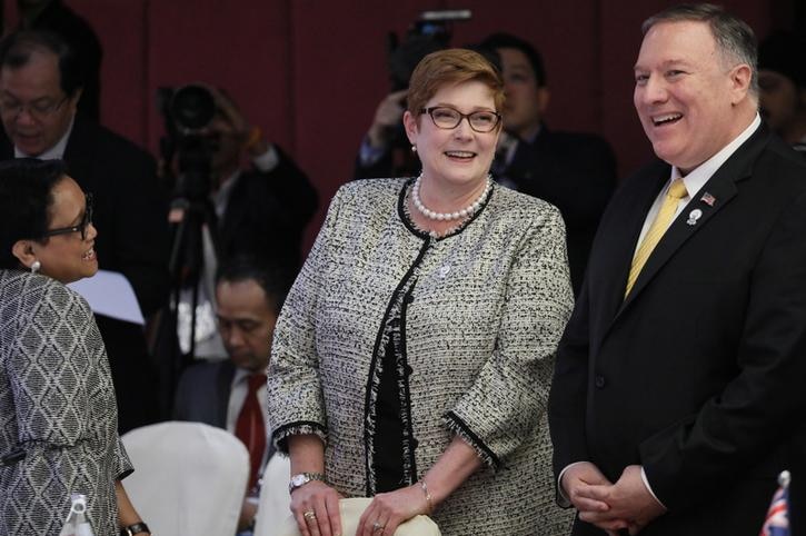 Marise Payne has her hands on a chair as she wears a black and white jacket, left, next to Mike Pompeo in a suit.