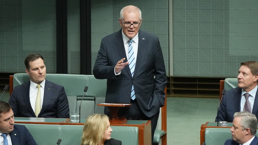 Scott Morrison gestures while standing in the House of Representatives