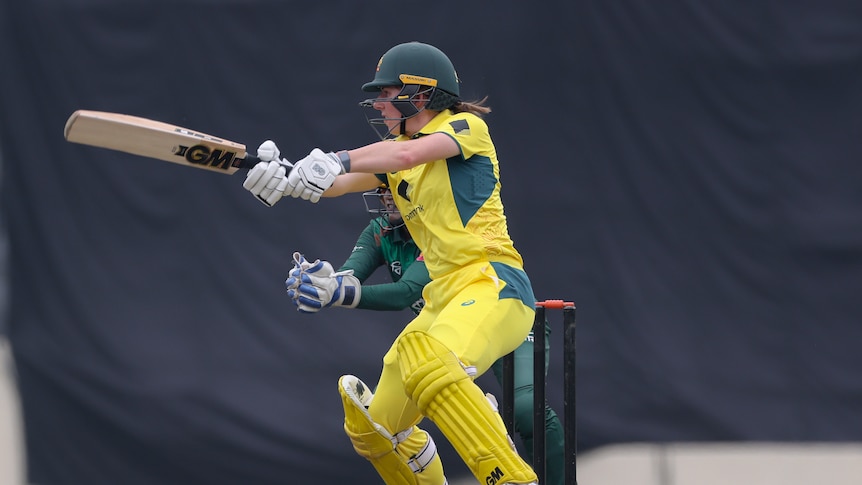 An Australia cricketer plays a cut shot during a match against Bangladesh