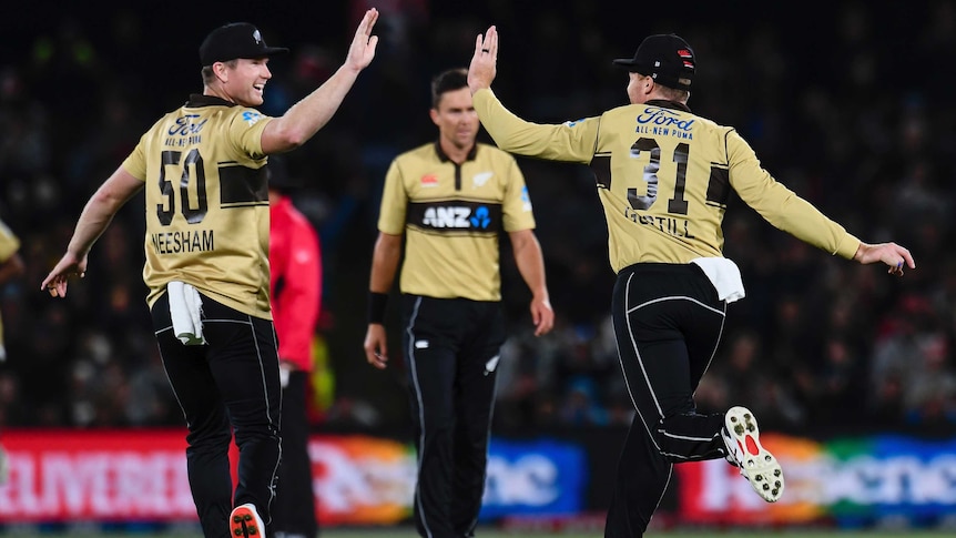 Two NZ cricketers get ready to high five in celebration after taking a wicket in T20 International.