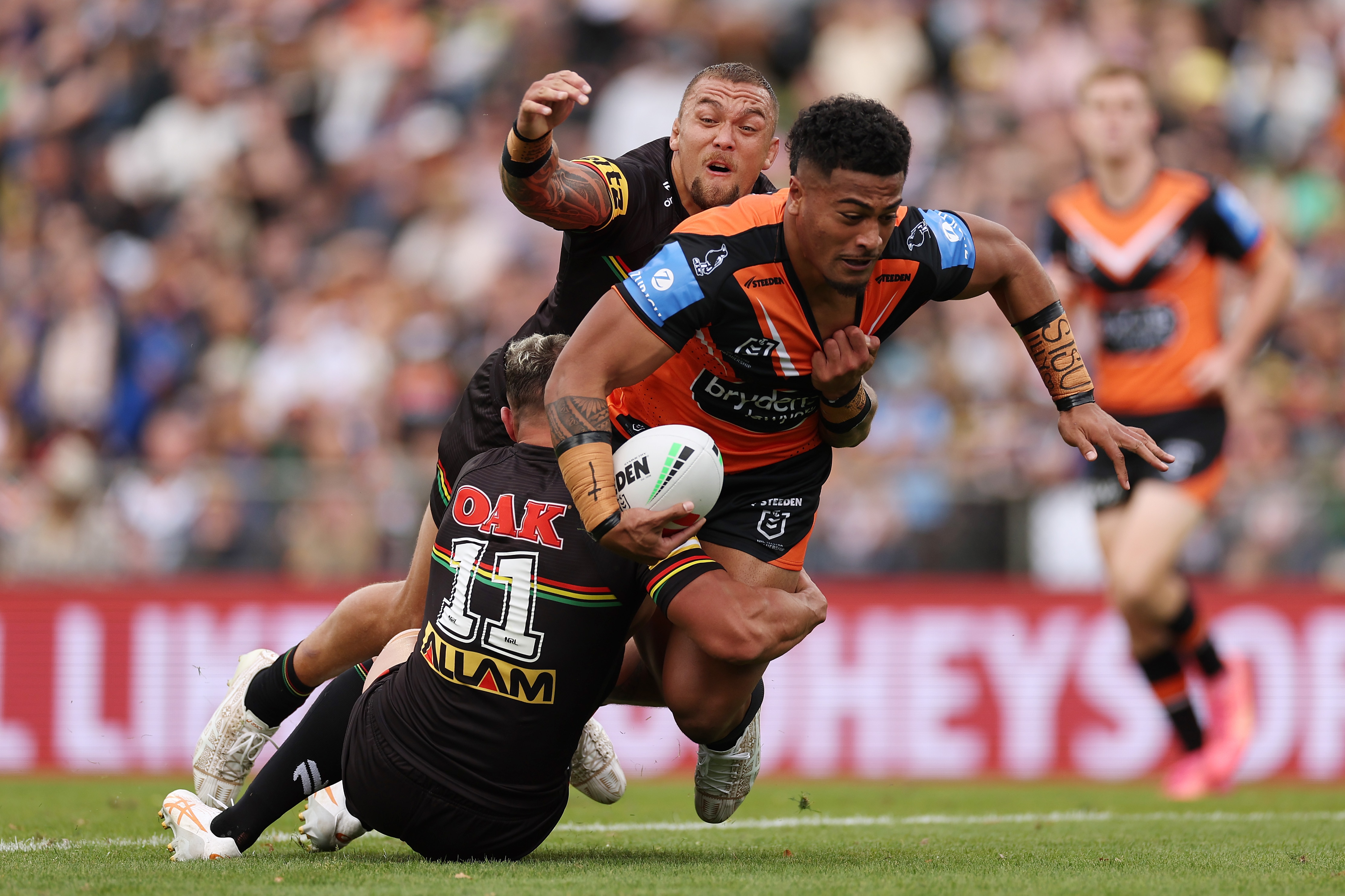A man runs the ball during a rugby league match