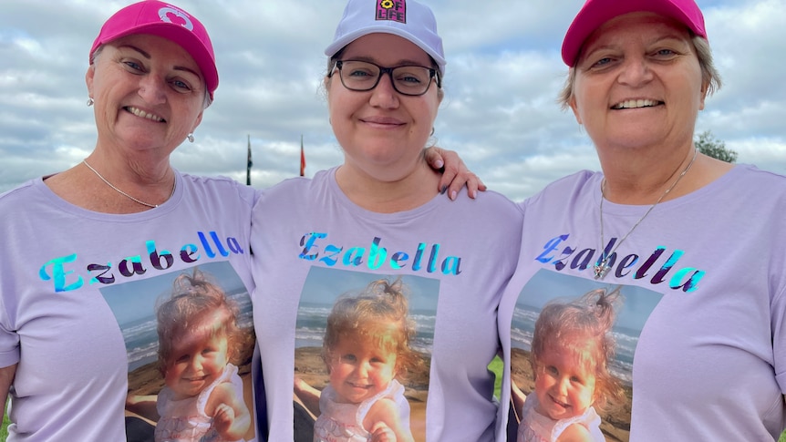 Mum Naomi Wilson (centre) with family taking part in the 2024 Gift of Life Walk, wearing shirts with a photo of Ezabella. 