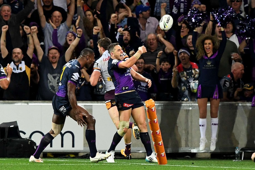 Billy Slater of the Storm celebrates after scoring his side's second try against the Broncos.