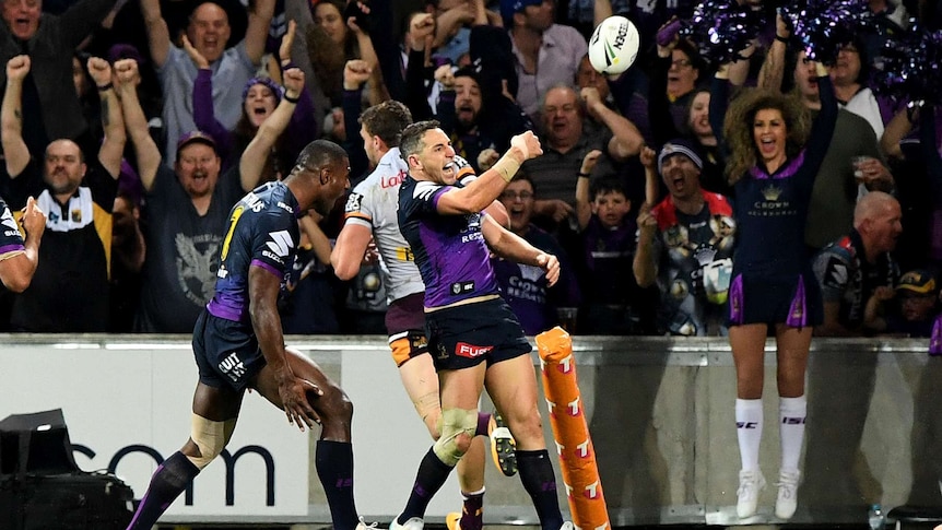 Billy Slater discards the ball as he rejoices