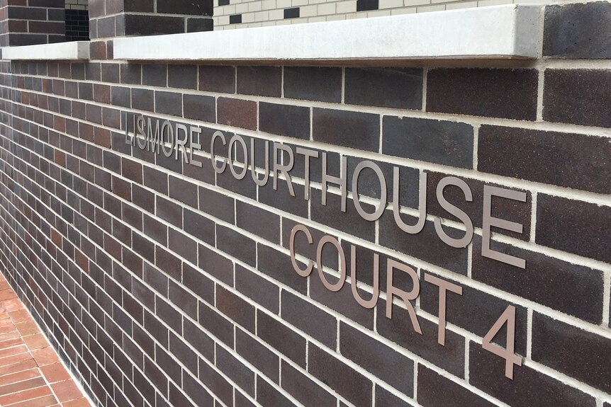 The dark brick facade of a courthouse.