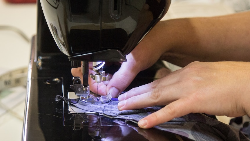 Hands using a sewing machine