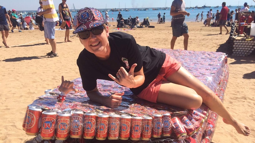 A competitor and beer can boat get ready for the 2016 Beer Can Regatta.