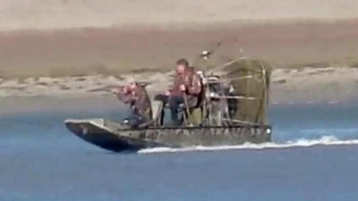 Gun raised on airboat