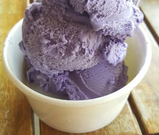 Lavender coloured icecream in a cup.