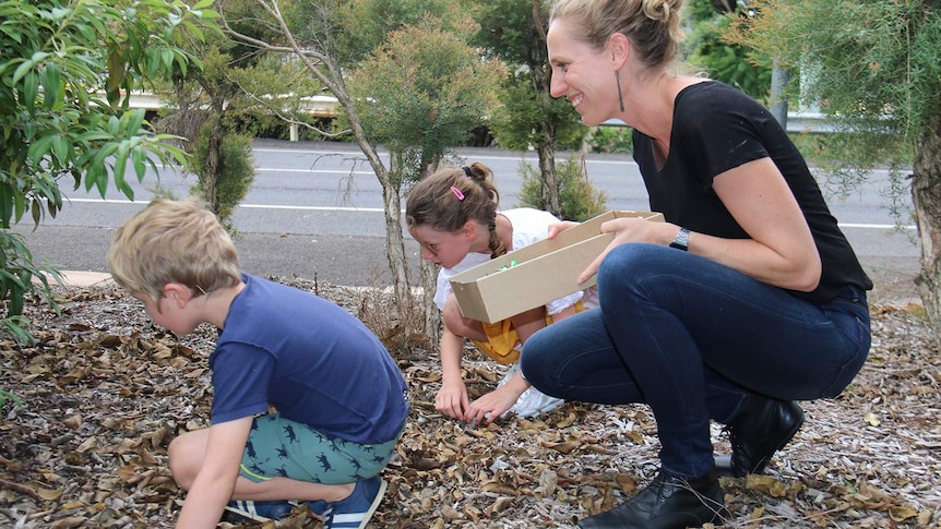 Kate Perry and her children Olive and Reginald doing a treasure hunt in an Ipswich park, west of Brisbane, in February 2018