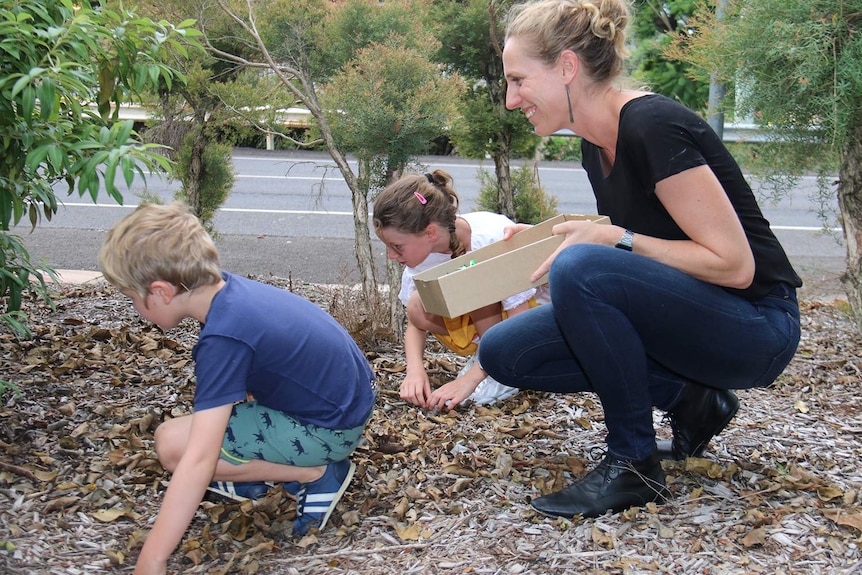 Kate Perry and her children Olive and Reginald doing a treasure hunt in an Ipswich park, west of Brisbane, in February 2018