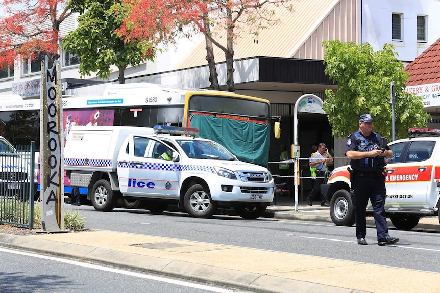 Police surround a damaged bus