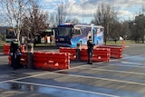 Police stand on a road