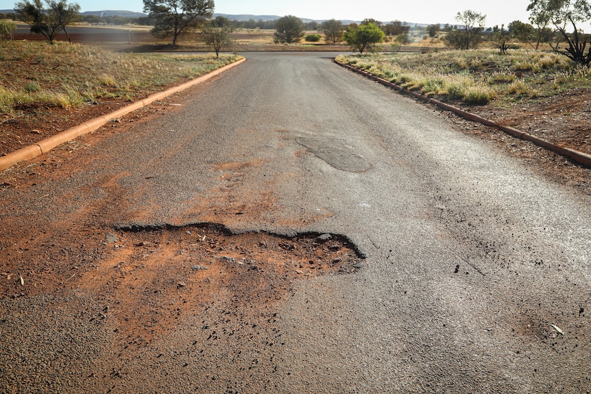 A road in Warburton with a large hole caused by underground water pipes bursting