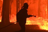 A silhouette of a firefighter surrounded by flames